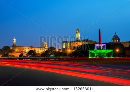 Delhi India. Illuminated Rashtrapati Bhavan an Parliament building in Delhi India. Car traffic trail lights. Dark sunset sky