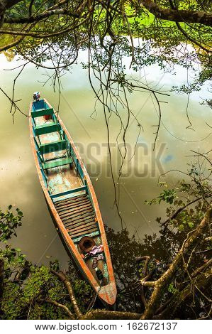 Wooden canoe in the Limoncocha lagoon at Ecuadorian Amazonia
