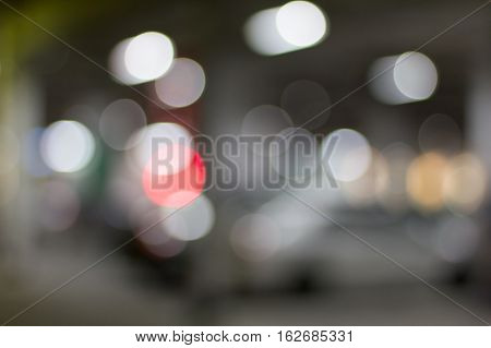 De focused/blur image of city at night. A man crossing the road. De focused blurred urban abstract traffic background.