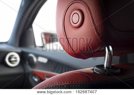 Modern sport car interior with red leather passenger headrest