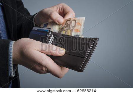 Man gets money from the wallet. Selective focus.