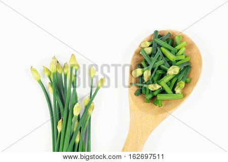 bunch of fresh chives on a wooden cutting board