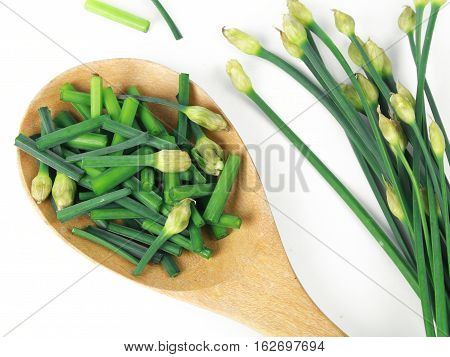 bunch of fresh chives on a wooden cutting board