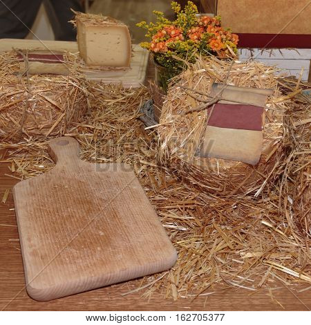 Aged Pecorino Cheese Cover with Decorative Straw and Wooden Cutting Board