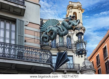 Barcelona. Chinese dragon on House of Umbrellas (Casa Bruno Cuadros) building on La Rambla. Catalonia Spain.
