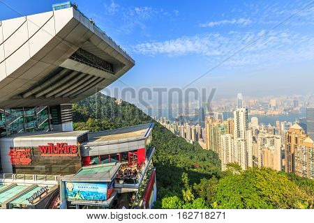 Hong Kong, China - December 7, 2016: The Peak Tower and rooftop restaurant atop Victoria Peak in a sunny day. The Peak Tower and spectacular views of Victoria Harbour and skyline of Hong Kong.
