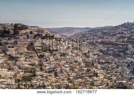 View of the Village of Siloam from the opposite hill neighborhood of Silwan outside the walls of the Old City of Jerusalem Israel