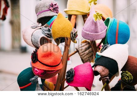 Close View Of Various Colorful Traditional European Caps Hats At Winter Christmas Market. Souvenir From Europe.
