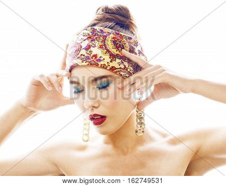 young pretty modern girl with bright shawl on head emotional posing isolated on white background, asian people ethnicity