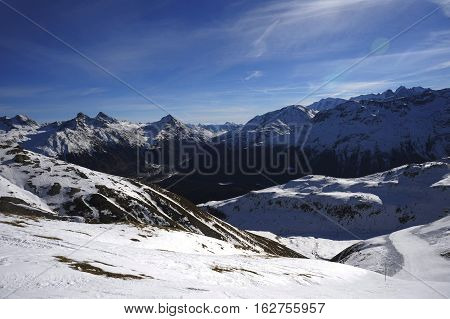 amazing scenic view of snow mountains and ski resort in Switzerland Europe on a cold sunny day with blue sky at Saint Moritz Corvatsch peak in Engadin in winter vacation and holiday concept