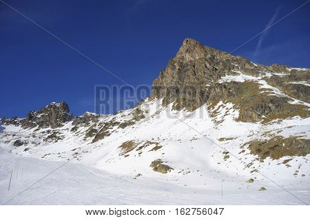 amazing scenic view of snow mountains and ski resort in Switzerland Europe on a cold sunny day with blue sky at Saint Moritz Corvatsch peak in Engadin in winter vacation and holiday concept