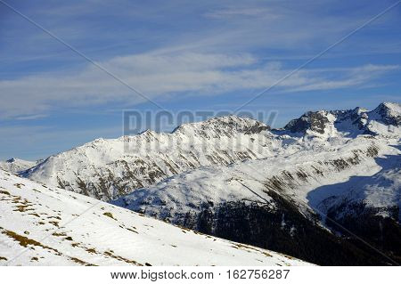 amazing scenic view of snow mountains and ski resort in Switzerland Europe on a cold sunny day with blue sky at Saint Moritz Corvatsch peak in Engadin in winter vacation and holiday concept