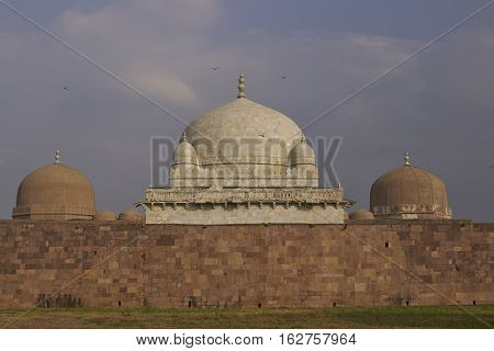 MANDU, MADHYA PRADESH, INDIA - NOVEMBER 18, 2008: Ancient islamic tomb of Hoshang Shah in the hilltop fortress of Mandu in Madya Pradesh, India. White marble building. 15th Century AD