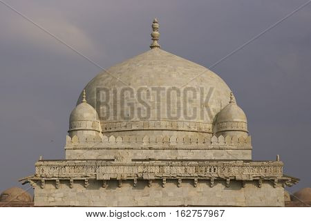 MANDU, MADHYA PRADESH, INDIA - NOVEMBER 18, 2008: Ancient islamic tomb of Hoshang Shah in the hilltop fortress of Mandu in Madya Pradesh, India. White marble building. 15th Century AD
