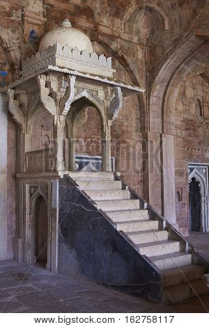 MANDU, MADHYA PRADESH, INDIA - NOVEMBER 18, 2008: Steps leading to a stone platform or mimbar, used by a preacher, inside the prayer hall of  the mosque of Ashrafi Mahal Mosque in the hilltop fortress of Mandu in Madya Pradesh, India. 15th Century AD