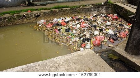 Trash clogs a dirty river photo taken in Bogor Indonesia java