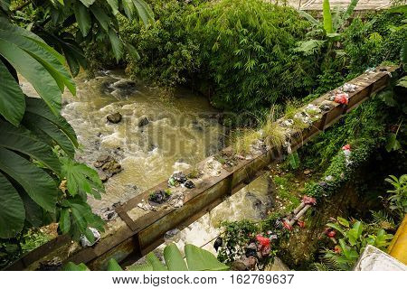 A dirty river flow with plastic waste photo taken in Bogor Indonesia java