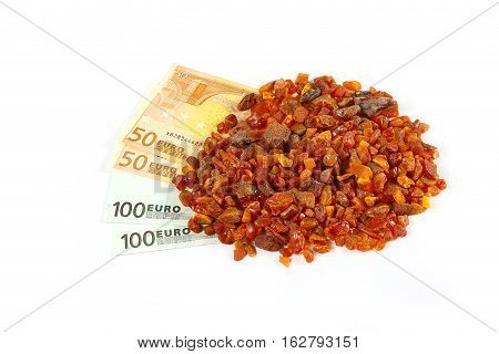 unwrought precious mineral amber and cash Euro banknotes as payment