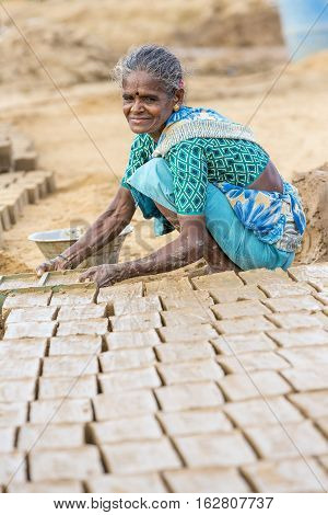 Illustrative image. Pondicherry Tamil Nadu India - July 03 2014. Poor woman worker in small village very hard work for little money roupies