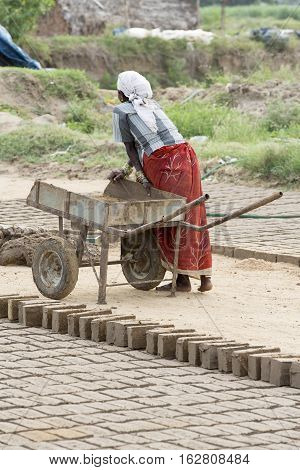 Illustrative image. Pondicherry Tamil Nadu India - July 03 2014. Poor woman worker in small village very hard work for little money roupies