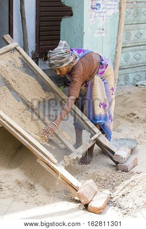 Illustrative image. Pondicherry Tamil Nadu India - July 03 2014. Poor woman worker in small village very hard work for little money roupies