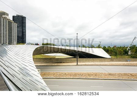 Chicago IL USA october 28 2016: The BP Bridge in Millennium Park Chicago Illinois USA Chicago skyline in the background sunny winter day