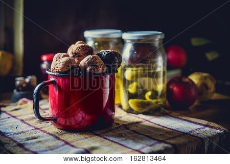 Red Tin Cup Full Of Walnus