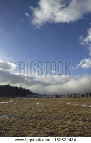 amazing landscape scenic view of Engadin valley in Switzerland Sils Maria village with snow on Alp mountains and frozen ground on a cold sunny winter day in tourism and holiday destination