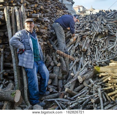 Istanbul Turkey - January 19 2014: Firewood for oven and stove heat source. Wood processing industry tree trunks piled up. There are people working on the firewood stacked in the photo.