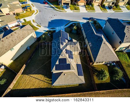 Sunset Suburban Homes North of Austin near Round Rock. Texas expands more and more homes are built in Modern Neighborhood Communities One House with Solar Panels providing clean renewable energy