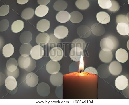 Abstract - burning candle with blur light on black background