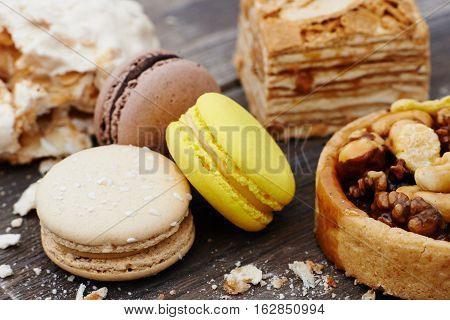 Sweet pecan cupcake, macaron and meringue on wooden table