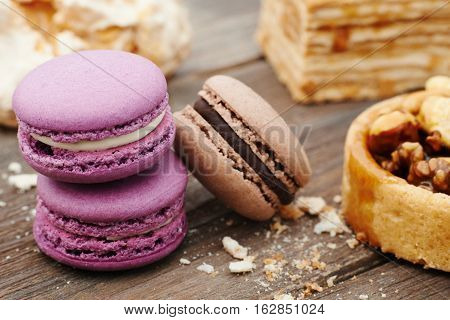 Sweet pecan cupcake, macaron and meringue on wooden table