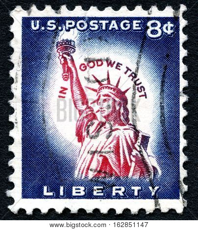 UNITED STATES OF AMERICA - CIRCA 1954: A used postage stamp from the USA celebrating Liberty by depicting an illustration of the Statue of Liberty with the phrase In God We Trust circa 1954.