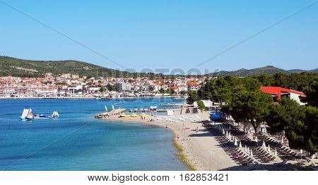 Beautiful pine beach on the background of the cityscape of Vodice in Croatia.