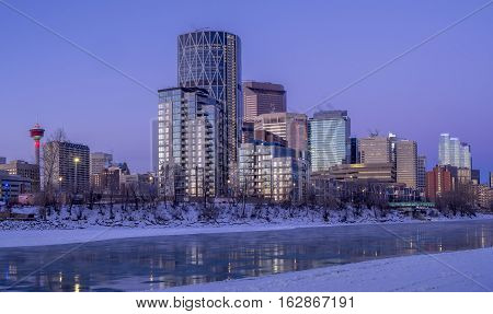 CALGARY, CANADA - DEC 17: Calgary's skyline at sunrise on a cold winter day on December 17, 2016 in Calgary, Alberta. Calgary is home to many oil companies. The Bow River is visible.