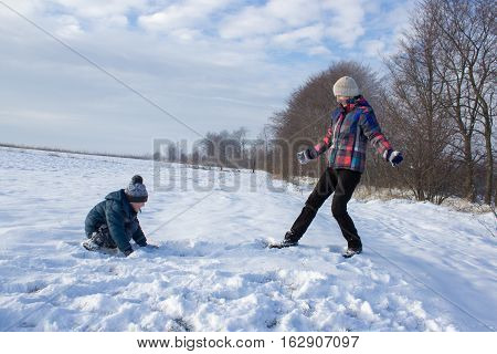 winter recreation aunt and nephew in the snow