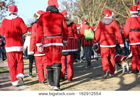 People With Red Santa Claus Clothes Run In The Public Park Of Th
