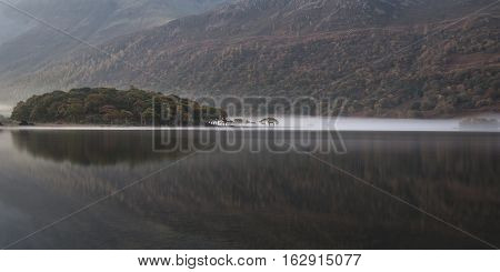 Beautiful Autumn Fall Landscape Image Of Crummock Water At Sunrise In Lake District England