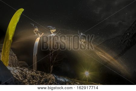 Skier jumping freestyle freerider at night in the snow. blur exposure