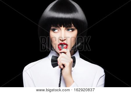 Sexy woman with red lips in wig bite whip portrait bdsm isolated on black