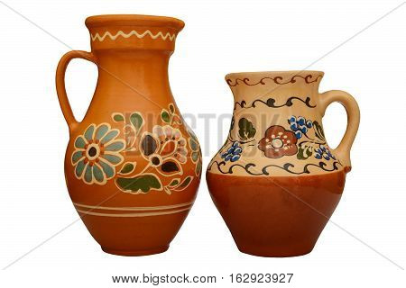 Traditional colored pottery. Painted ceramic jugful. Isolated, white background.