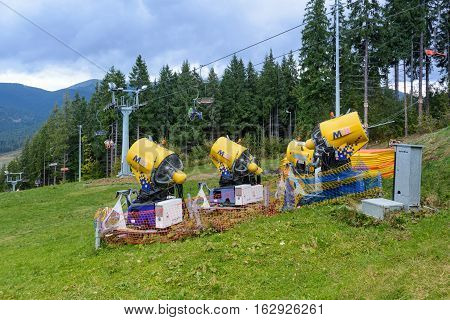 Snow gun. Snow making machine. Machine that makes artificial snow and blows it onto ski slopes.