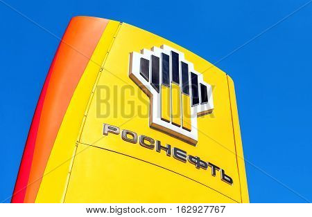 SAMARA RUSSIA - APRIL 16 2016: The emblem of the oil company Rosneft against the blue sky background. Rosneft is one of the largest russian oil companies