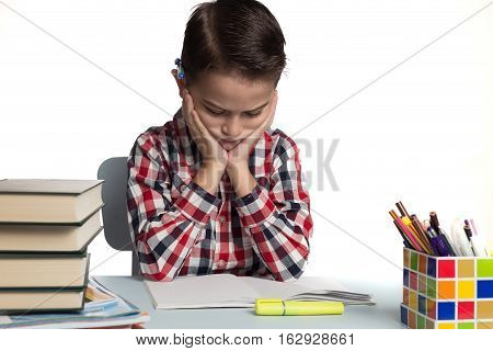 Student at his desk concentrated about his homework.