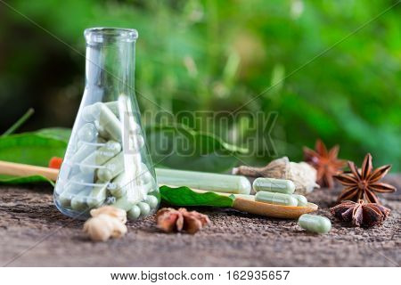Green Herb Powder Capsules And Erlenmeyer Flask