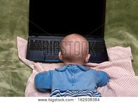A small child in front of a laptop
