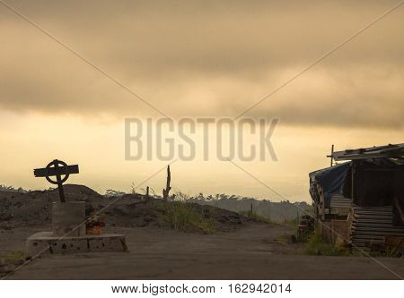Grim atmospheric photo of road with cross on the side, near Merapi Volcano, Java, Indonesia