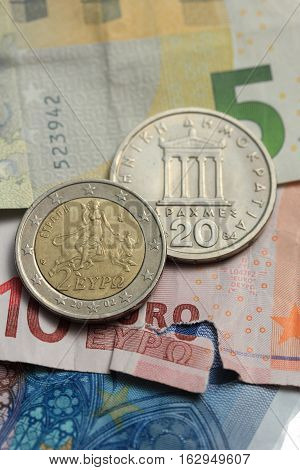 Vintage greek Drachma coins on european banknotes