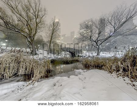 Gapstow Bridge is one of the icons of Central Park Manhattan in New York City during snow storm at night